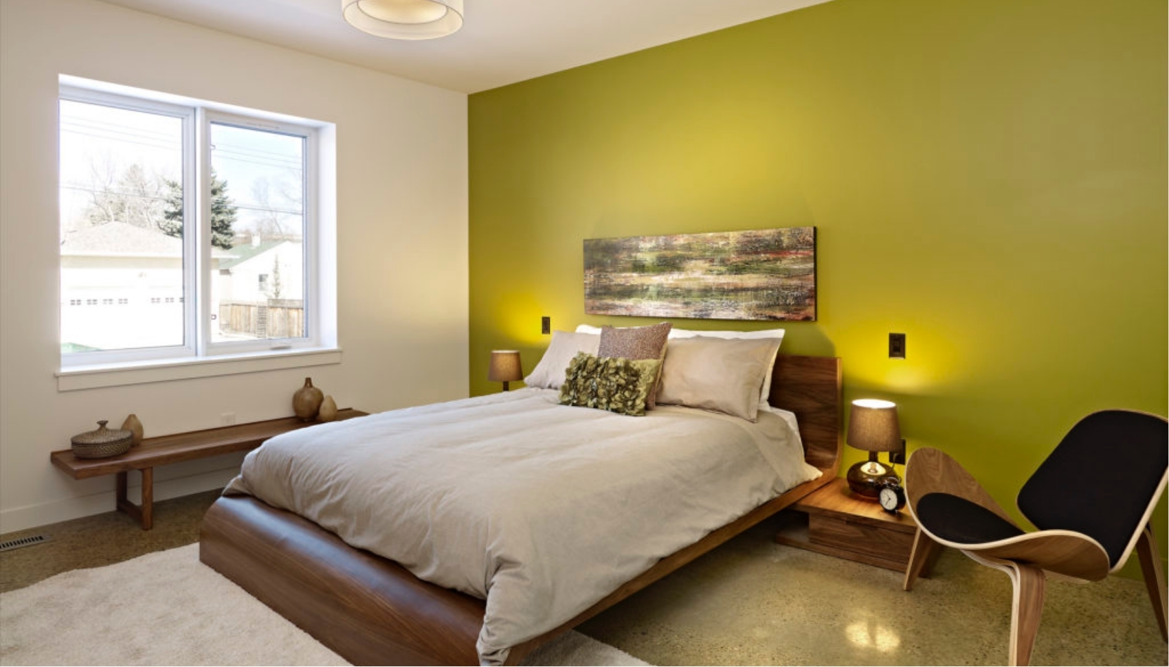 Modern bedroom with green accent room displays wide access areas and custom lighting for adaptive living