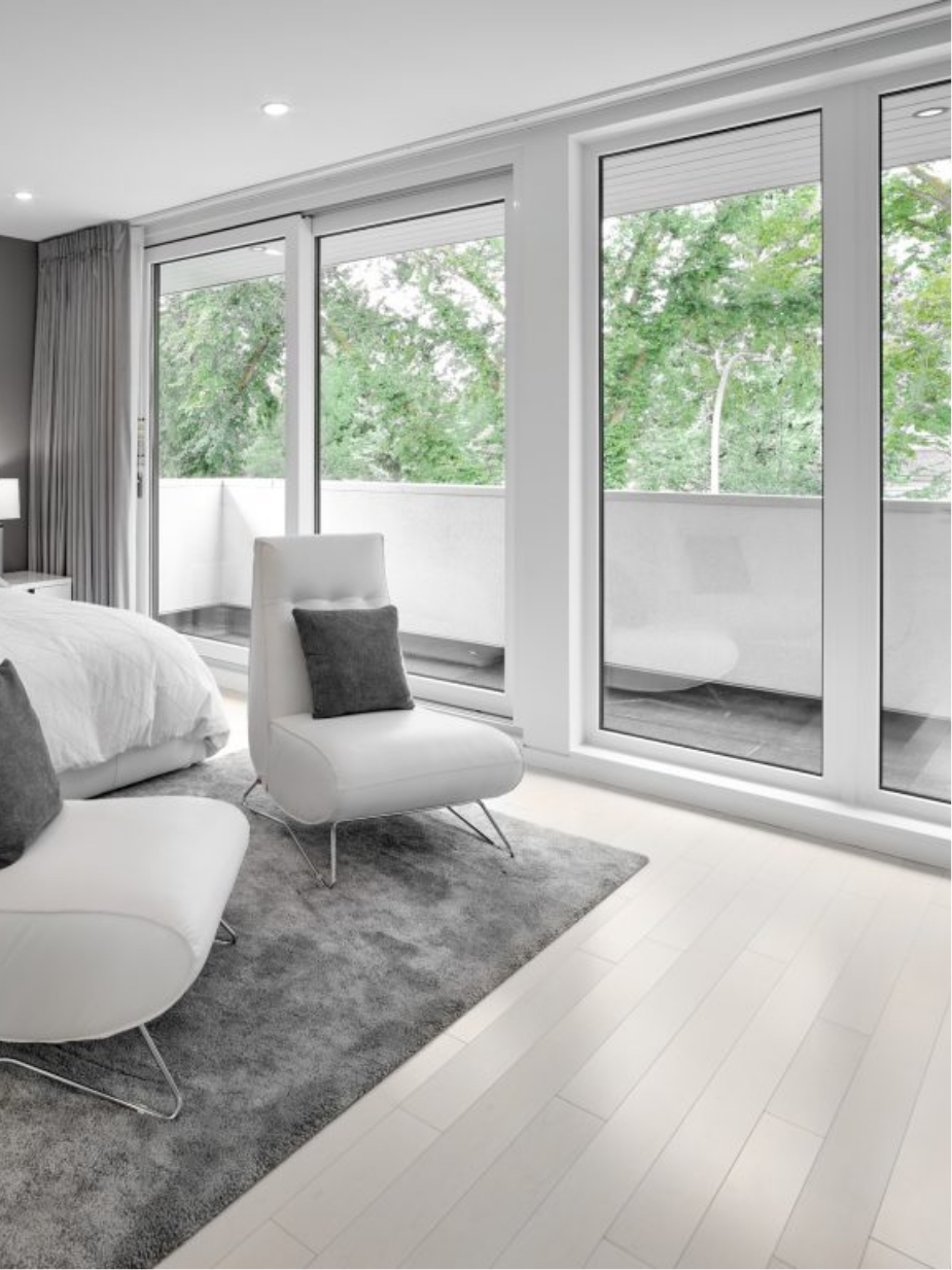 The master bedroom features flow to ceiling windows and a balcony retreat